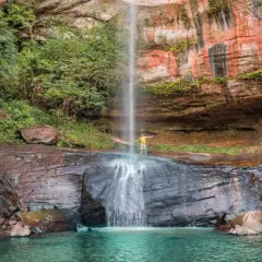 Cascada en Paraguay con un hombre disfrutando. ¡Un lugar increíble que ver en Paraguay!