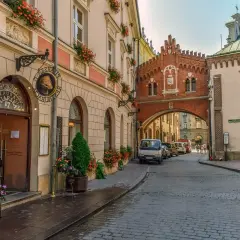 Un hombre mira desde una cafetería en Cracovia, una ciudad que ver en 3 días. Calles empedradas y arquitectura histórica.