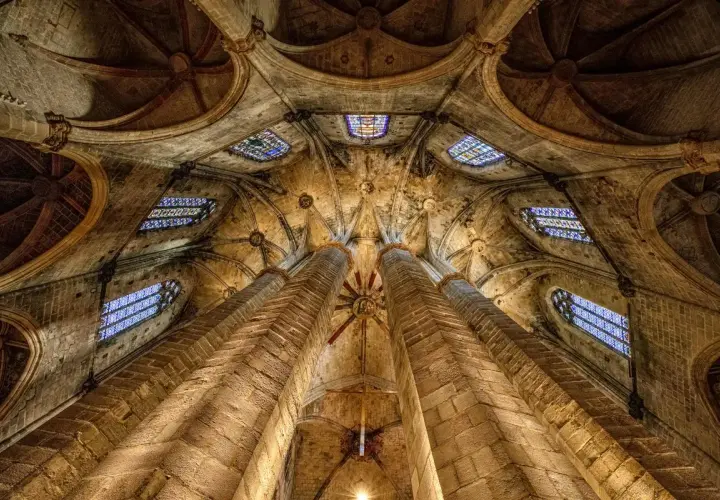 Bóveda gótica de piedra con vidrieras, perfecta para un free tour Barcelona.