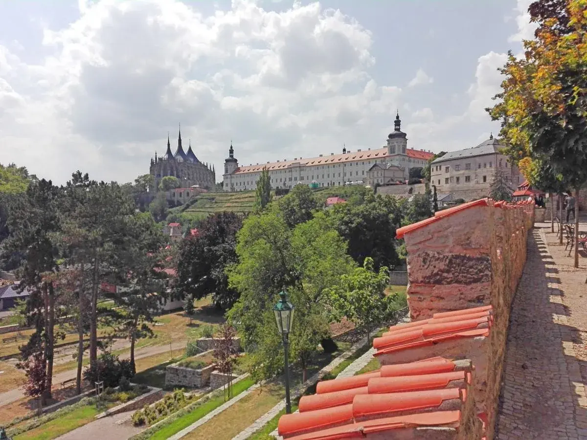 Vista panorámica de un pueblo con una iglesia gótica y un monasterio. Ideal para excursiones en Prague.